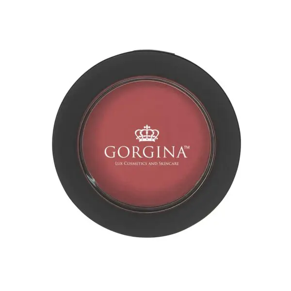 A round makeup compact with a black rim labeled "Gorgina Lux Cosmetics and Skincare" contains blush in a warm pink shade.