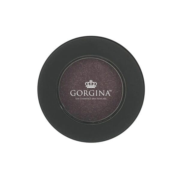 A circular container with a dark cosmetic product inside and "Gorgina Lux Cosmetics and Skincare" printed on the lid.