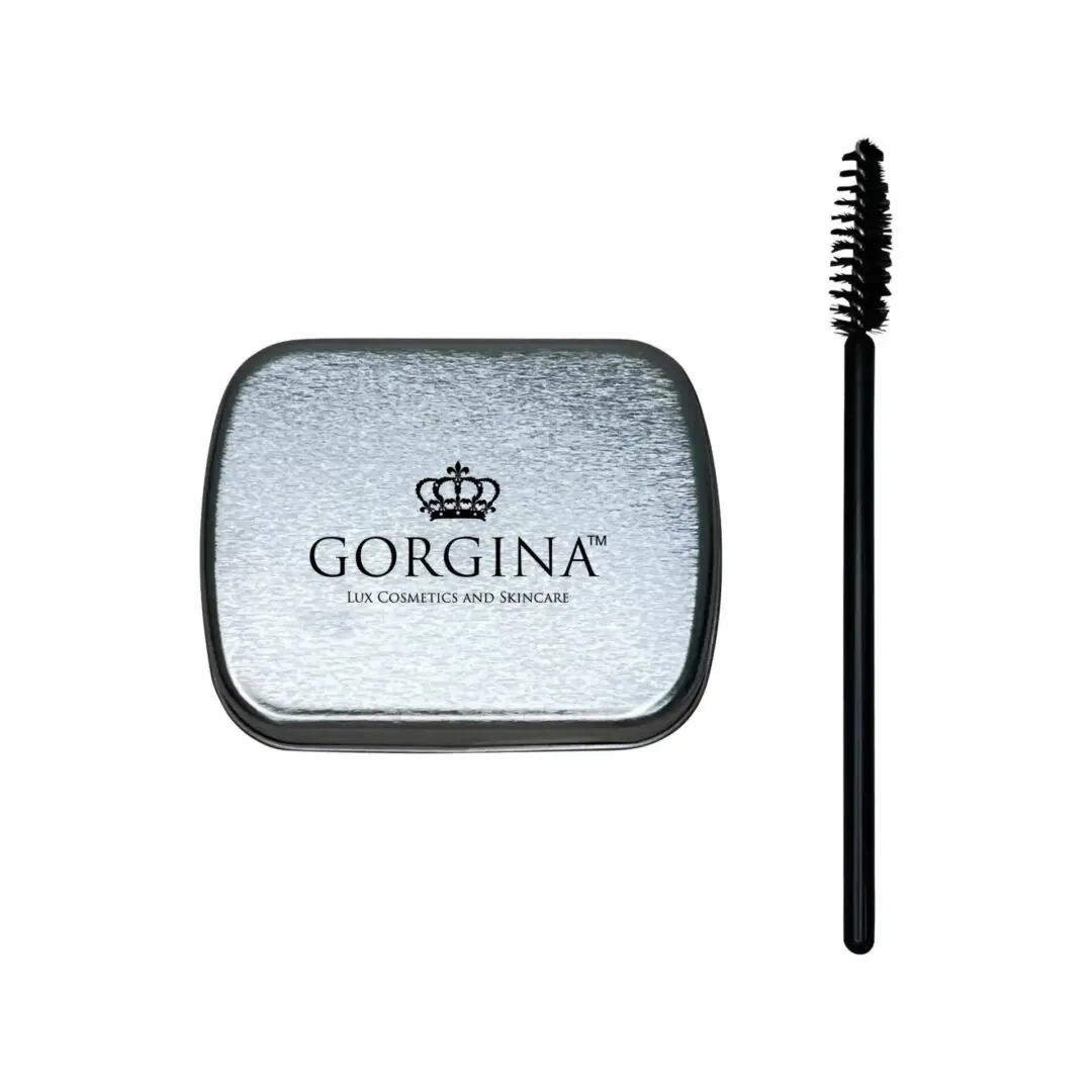 A silver tin labeled "Gorgina Lux Cosmetics and Skincare" next to a black mascara wand on a white background.