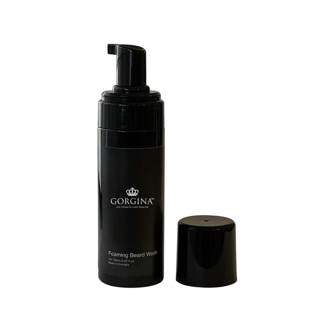 Black bottle of Gorgina Foaming Beard Wash with a pump dispenser, placed next to its cap.