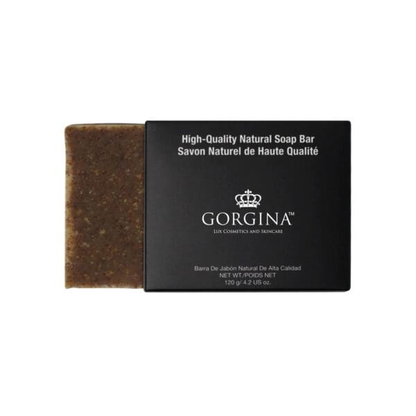 A bar of natural soap partially slides out of a black box labeled "Gorgina" with product details and branding text.