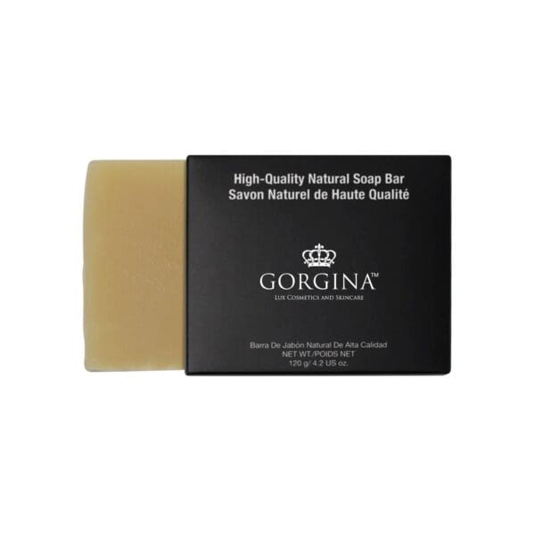 A beige soap bar partially slides out of a black box labeled "Gorgina," featuring multilingual text advertising high-quality natural soap.