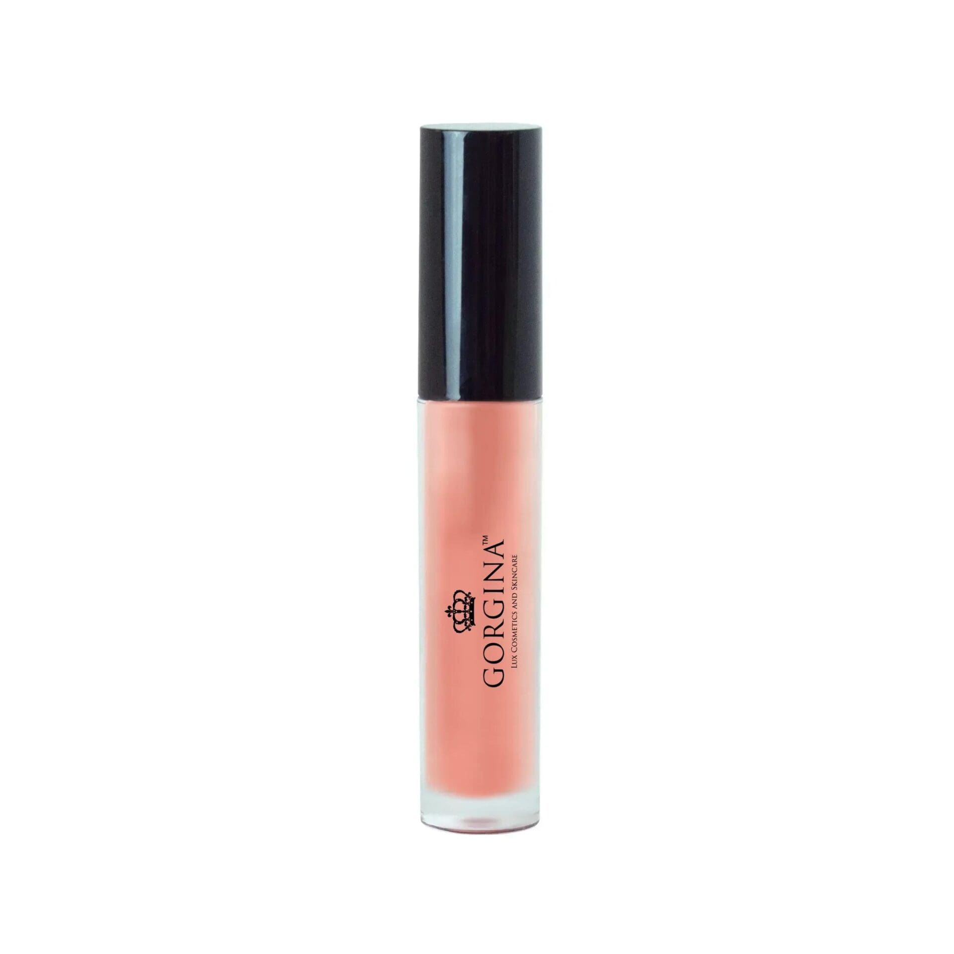 A tube of Gorgina lip gloss with a peach-colored shade and a black cap.