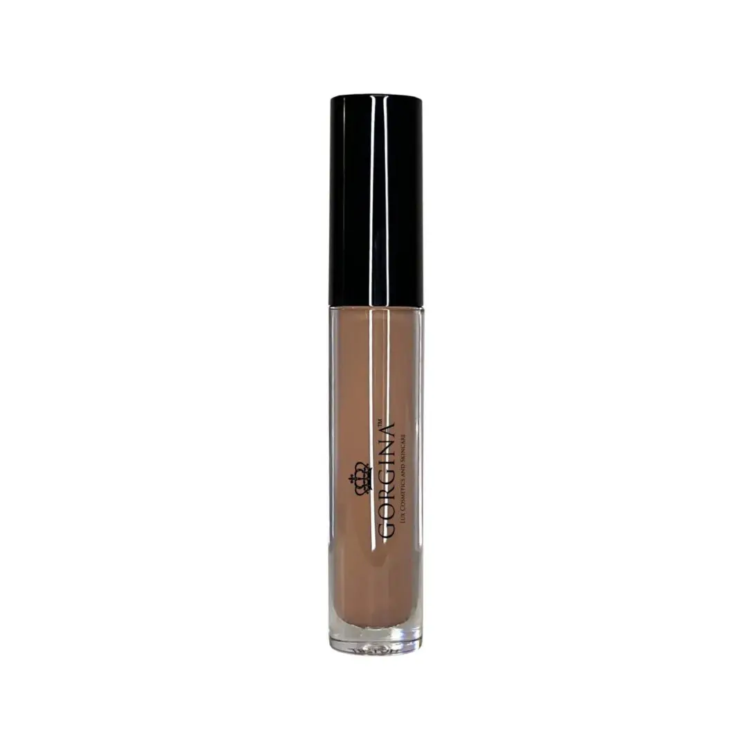 A tube of liquid foundation with a black cap and transparent body displaying the brand name "Corynne Hailey.