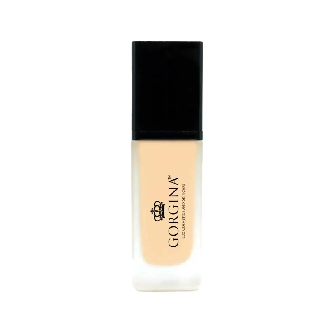 A bottle of liquid foundation labeled "Gorgina," featuring a black cap and a transparent bottle displaying the light beige product inside.