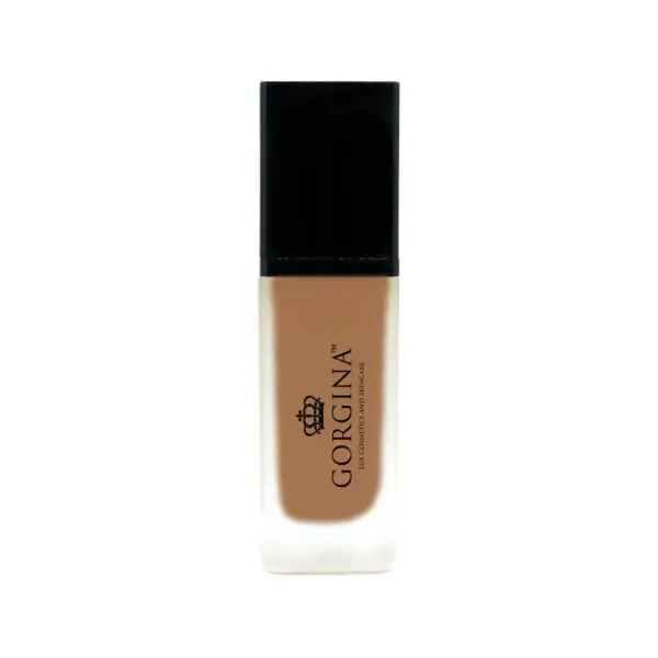 A bottle of Gorgina liquid foundation with a black cap and a frosted glass body showing a medium beige shade.