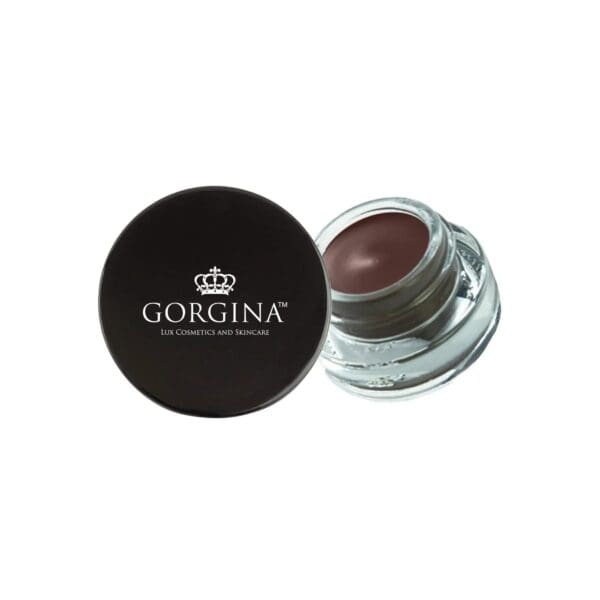 A small glass jar of brown makeup with a black lid labeled "Gorgina Lux Cosmetics and Skincare.