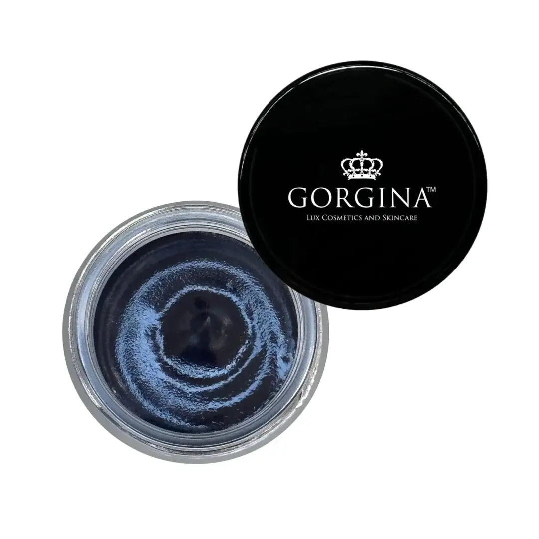 Open jar of dark blue cream with a black lid labeled "Gorgina Lux Cosmetics and Skincare.