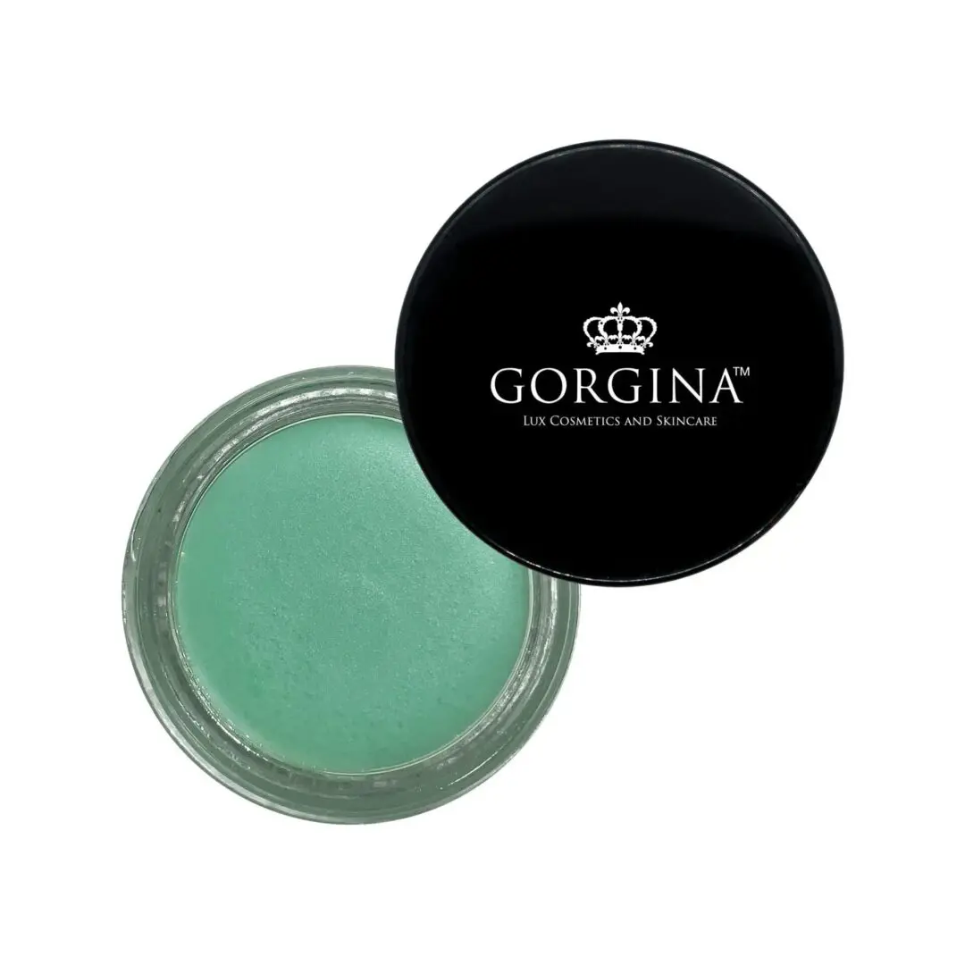 Open jar of mint green lip balm with a black lid displaying the brand name "Gorgina Lux Cosmetics and Skincare".