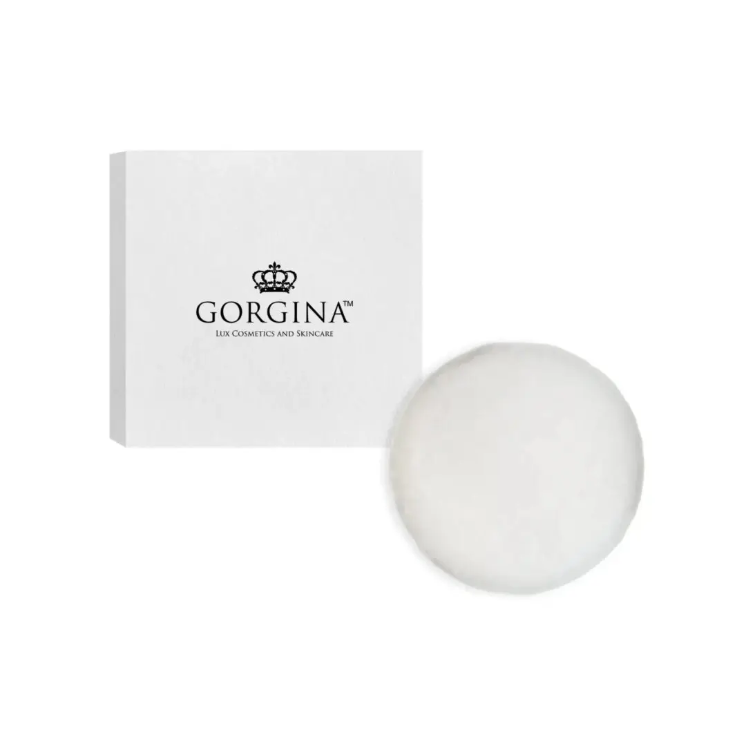 White box with "Gorgina Lux Cosmetics and Skincare" logo next to a round, white cosmetic puff on a plain white background.