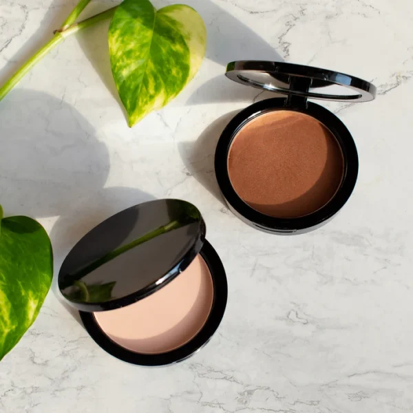 Two different types of bronzers sitting on a table.