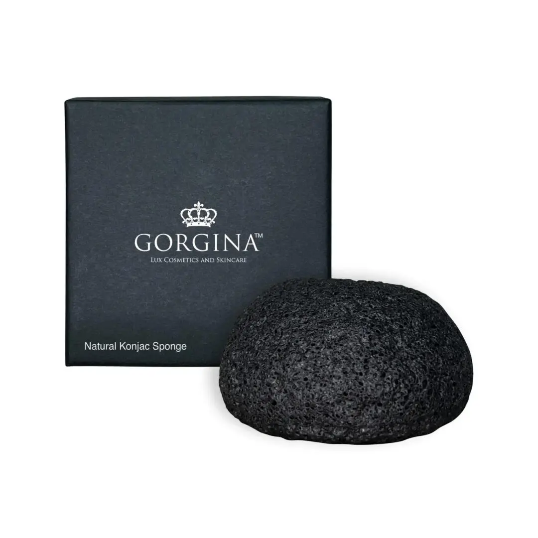 A black konjac sponge is placed in front of a dark box labeled "Gorgina Natural Konjac Sponge.