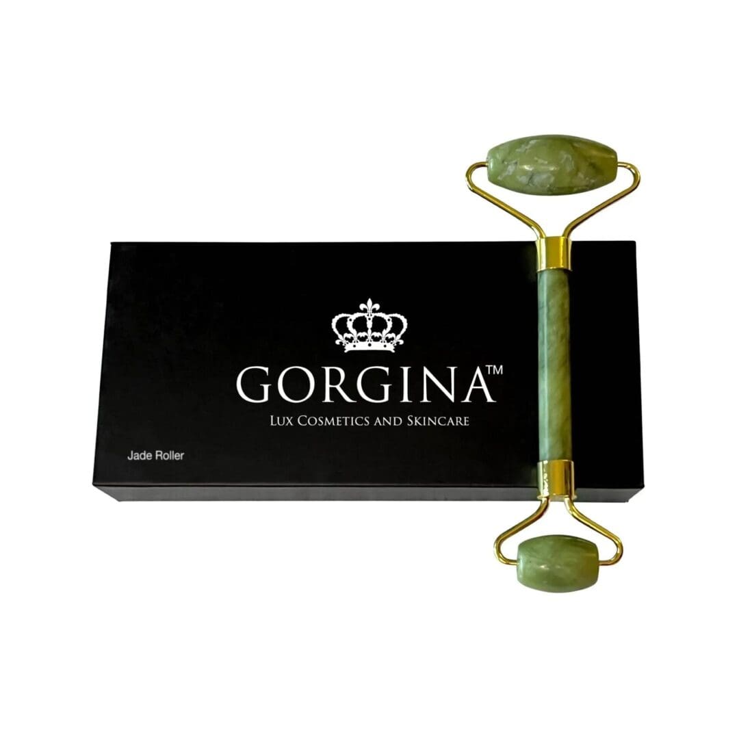 A jade roller rests on top of a black Gorgina Lux Cosmetics and Skincare box labeled "Jade Roller.