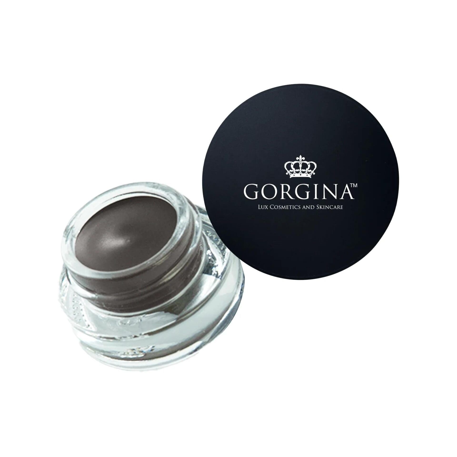 A small open glass jar containing dark cream eyeliner with a black lid labeled "Gorgina Lux Cosmetics and Skincare" placed beside it.