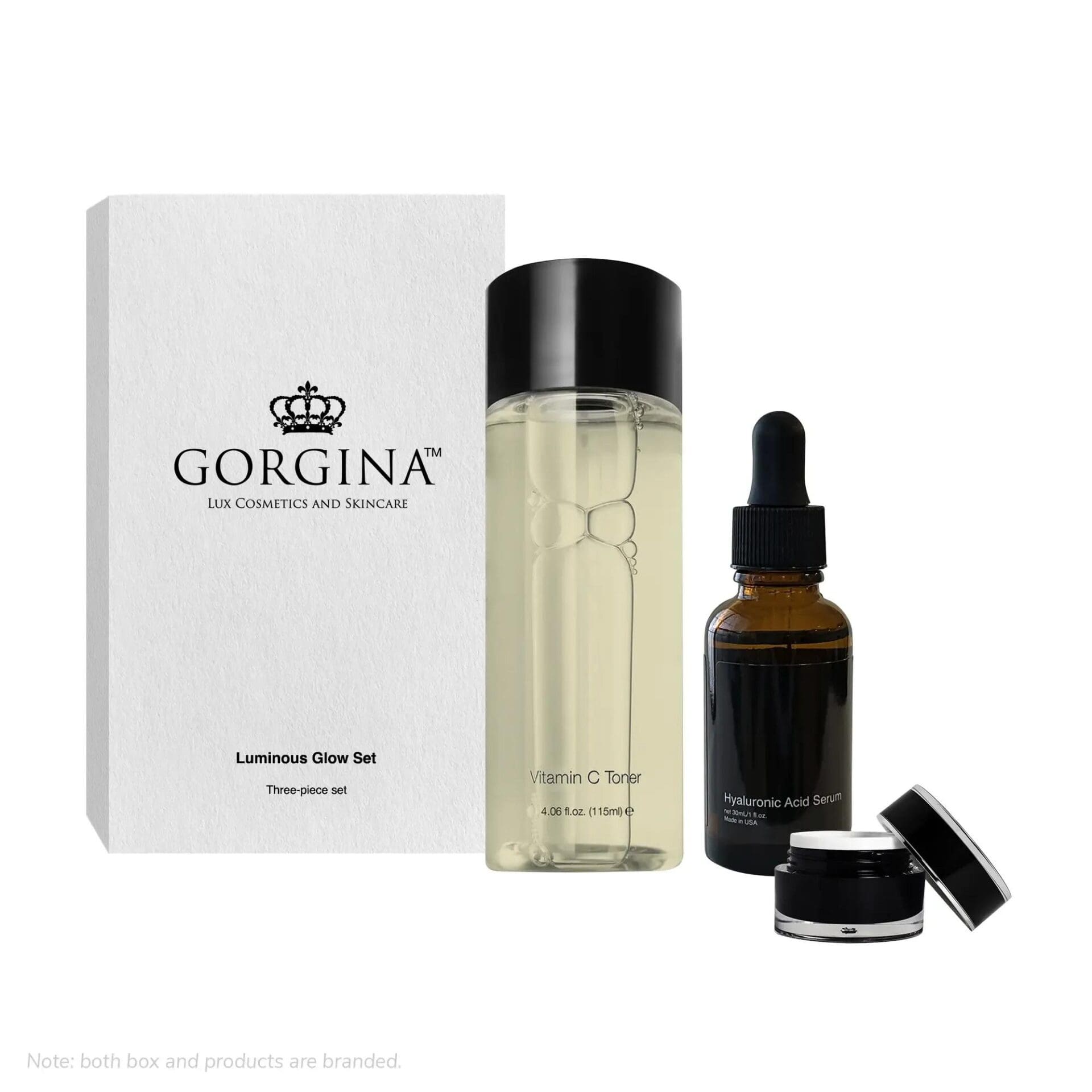 Gorgina Luminous Glow Set includes Vitamin C toner (clear bottle), hyaluronic acid serum (dropper bottle), and a small jar, beside a branded white box.