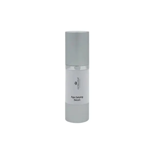 A silver and white bottle labeled "Age Defying Serum" from Coralina sits upright against a plain white background.