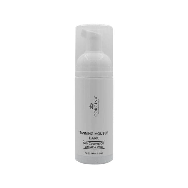A white bottle of Gorgina Tanning Mousse Dark with coconut oil and aloe vera, featuring a pump dispenser and 150g net weight label.