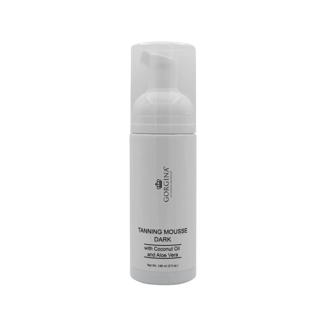 A white bottle of Gorgina Tanning Mousse Dark with coconut oil and aloe vera, featuring a pump dispenser and 150g net weight label.