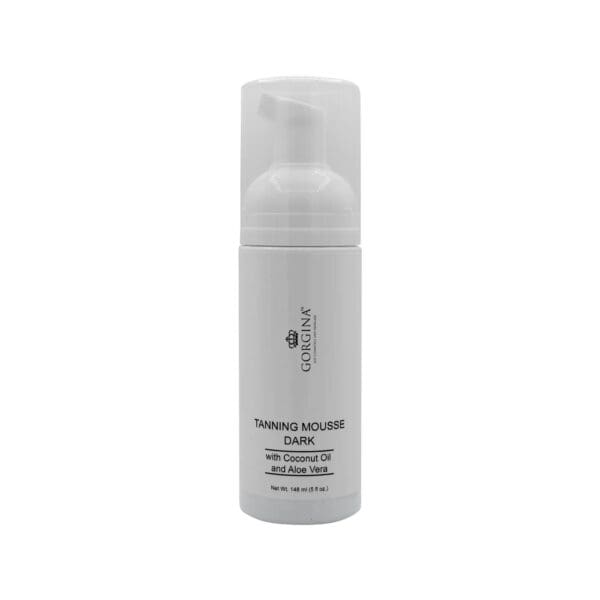A white bottle of Gorgina Tanning Mousse Dark with a pump dispenser, labeled as containing coconut oil and aloe vera, 148g (5 fl oz).