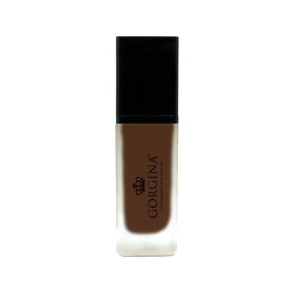 A bottle of Gorgina liquid foundation with a black cap and frosted glass body, containing dark brown makeup.