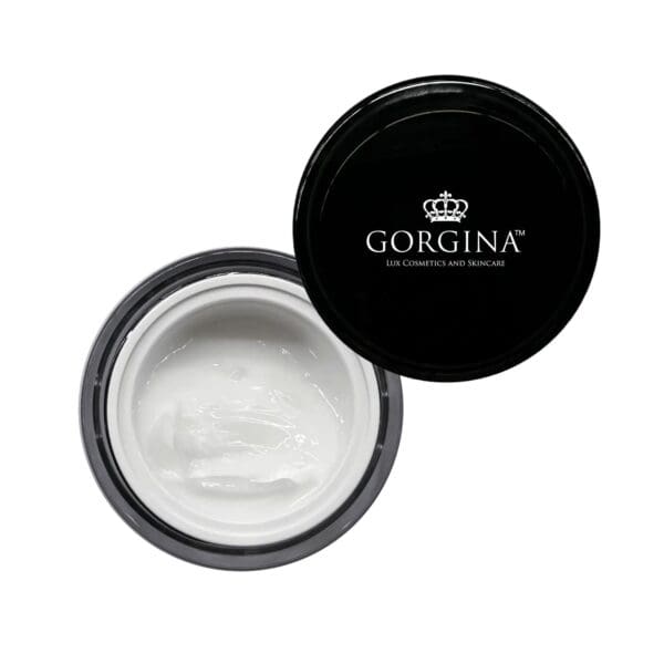 Open jar of white cream with a black lid placed beside it, displaying the text "Gorgina Lux Cosmetics and Skincare" and a crown logo on the lid.